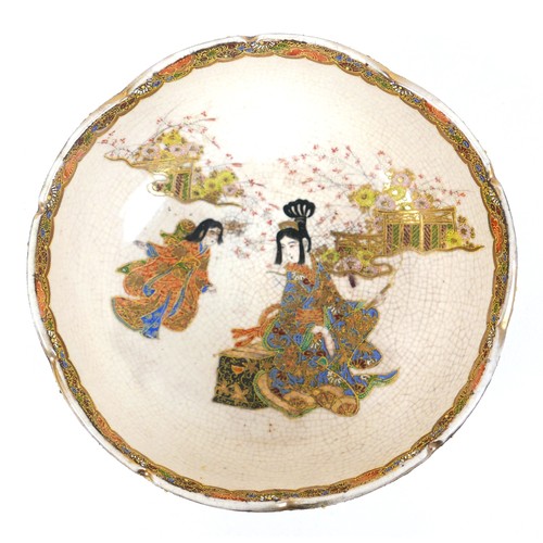 17 - A Japanese Satsuma ware bowl, hand painted with two ladies in a garden, with piped detail and gilt f... 