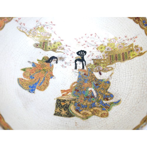 17 - A Japanese Satsuma ware bowl, hand painted with two ladies in a garden, with piped detail and gilt f... 
