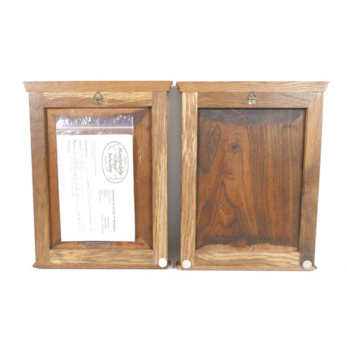 251 - A pair of Arts and Crafts carved wooden panels, mounted in oak frames, each 26.5 by 37cm high, with ... 