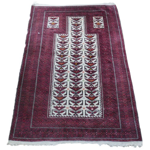 531 - A 20th century woollen Baluch prayer rug, with caucasian ground centre and red ground borders, 145 b... 