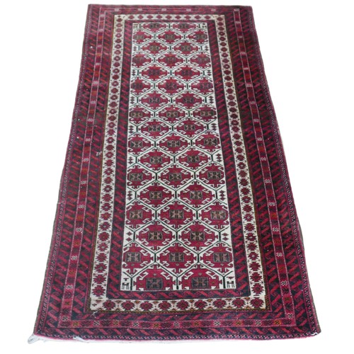 540 - A 20th century Baluch woollen rug, with caucasian ground centre, red ground borders, 176 by 90cm.