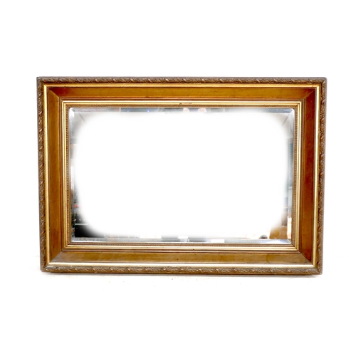 487 - An Edwardian wall mirror, with rectangular bevelled plate, and gilt frame, 86 by 7 by 60cm.