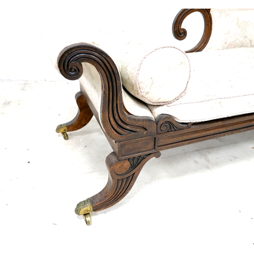 544 - A Regency style oak chaise longue, with scrolling detail and reeded decoration, upholstered in pale ... 