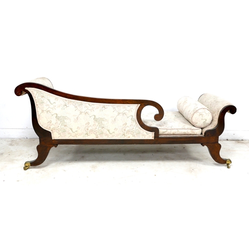 544 - A Regency style oak chaise longue, with scrolling detail and reeded decoration, upholstered in pale ... 