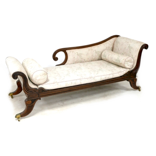 544 - A Regency style oak chaise longue, with scrolling detail and reeded decoration, upholstered in pale ... 