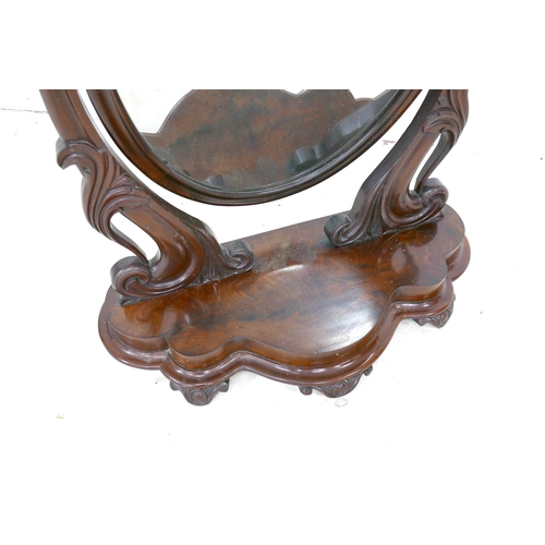 485 - A Victorian mahogany toilet mirror, oval swing plate, shaped base, 67 by 31 by 80cm high.