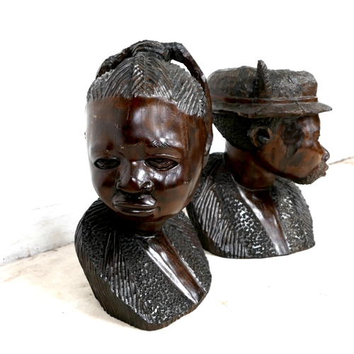 255 - A pair of African hardwood carved sculptures, modelled as a woman, 55cm and man wearing a hat, 53cm ... 