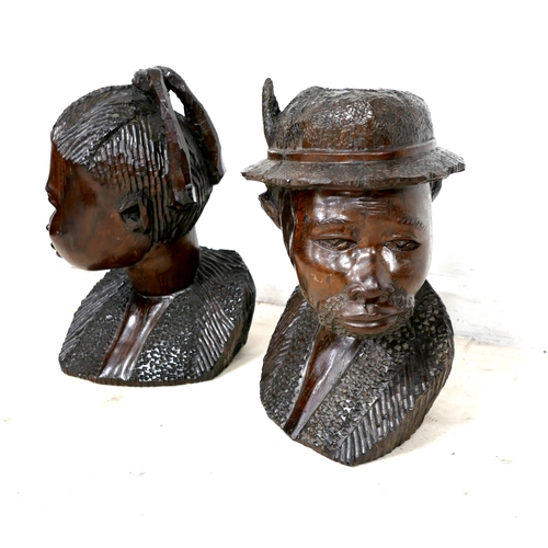 255 - A pair of African hardwood carved sculptures, modelled as a woman, 55cm and man wearing a hat, 53cm ... 