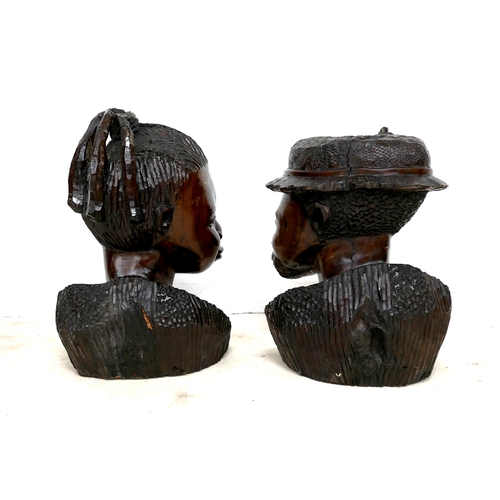 255 - A pair of African hardwood carved sculptures, modelled as a woman, 55cm and man wearing a hat, 53cm ... 