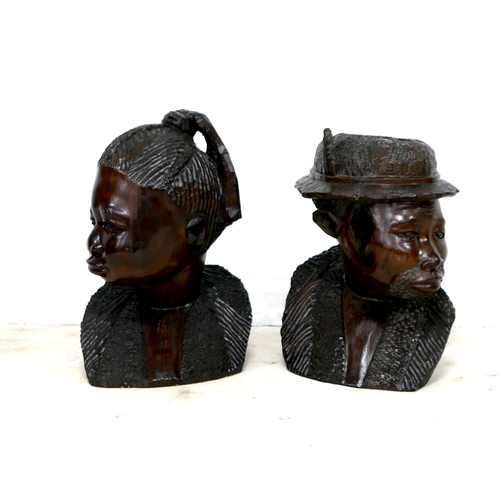 255 - A pair of African hardwood carved sculptures, modelled as a woman, 55cm and man wearing a hat, 53cm ... 