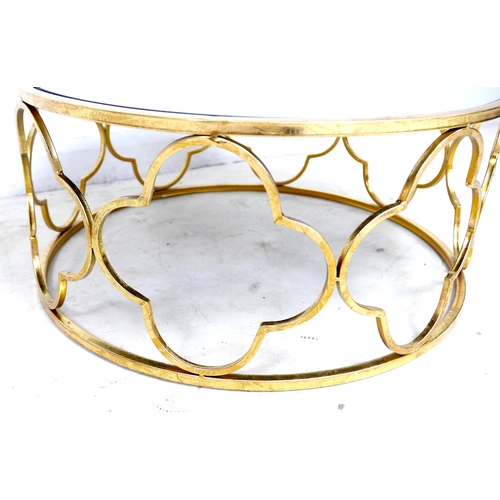 510 - A modern mirror topped coffee table, the circular surface on a brass effect open frame base formed o... 