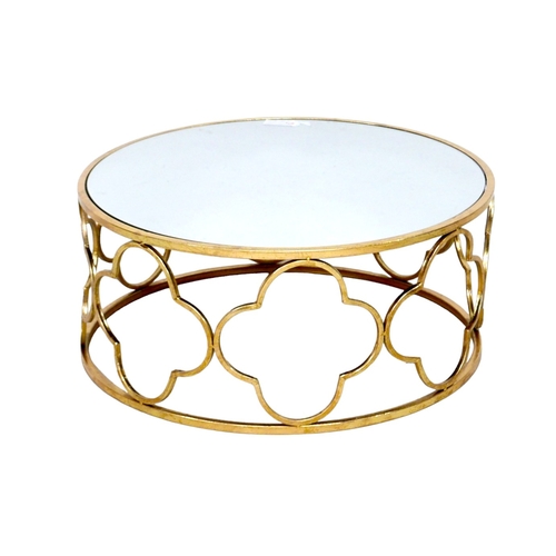 510 - A modern mirror topped coffee table, the circular surface on a brass effect open frame base formed o... 