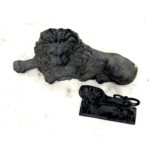 338 - A cast iron figure, in the form of a recumbent lion, 65 by 36cm high, together with a cast iron door... 