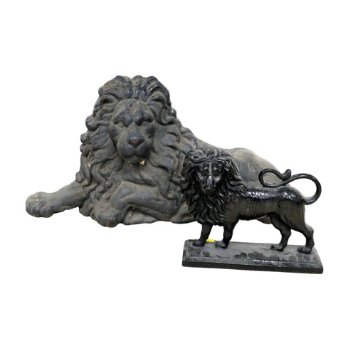 338 - A cast iron figure, in the form of a recumbent lion, 65 by 36cm high, together with a cast iron door... 