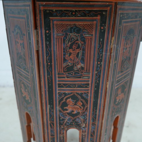 519 - A Persian 19th century octagonal side table, decorated in iron red and black with a series of interi... 