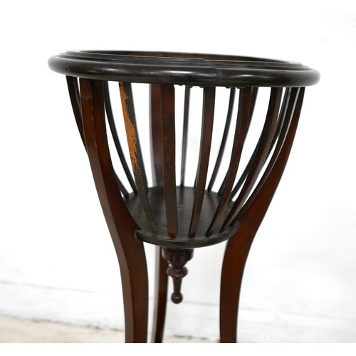 512 - An Edwardian mahogany jardiniere stand, 36 by 90cm high, together with an oak stick stand with metal... 