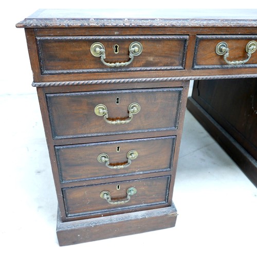 548 - An Edwardian mahogany twin pedestal partners desk, with a leather inset top above nine drawers, oppo... 