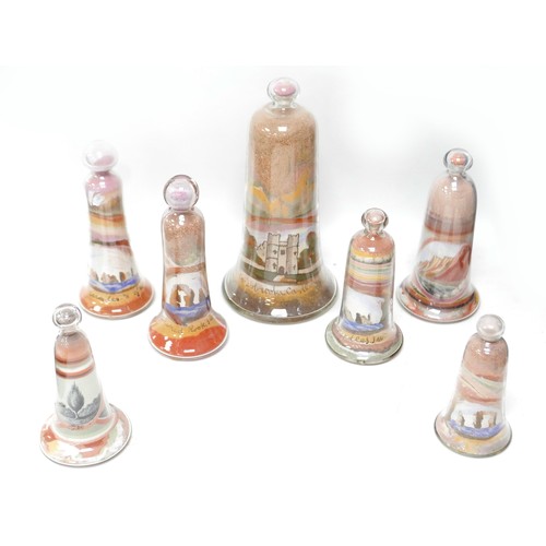 174 - A collection of seven Victorian Alum Bay coloured sand dome ornaments, ranging from 12cm to 22cm hig... 