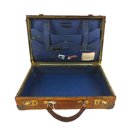 312 - An early 1900s crocodile attache case with a fitted interior, 36cm by 23cm by 9.5cm tall