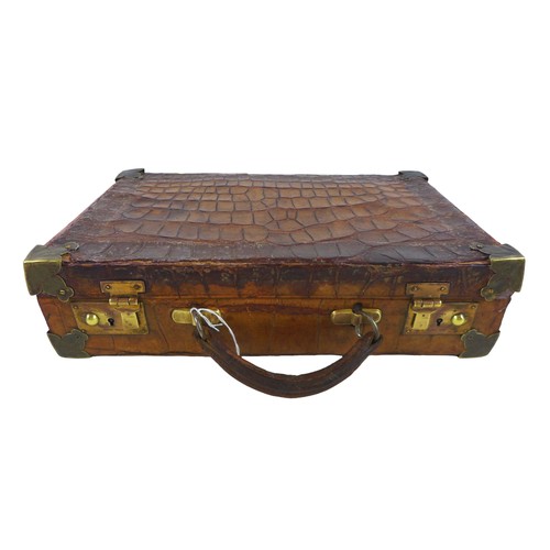 312 - An early 1900s crocodile attache case with a fitted interior, 36cm by 23cm by 9.5cm tall