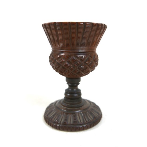 256 - A 19th century carved treen nutmeg grater and a treen eggcup, the grater measures 4.5cm by 6.5cm and... 