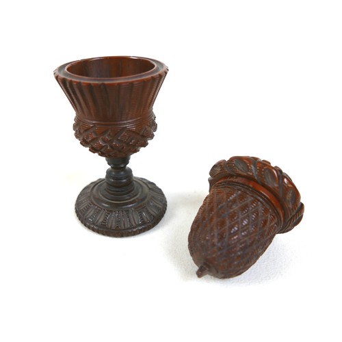 256 - A 19th century carved treen nutmeg grater and a treen eggcup, the grater measures 4.5cm by 6.5cm and... 