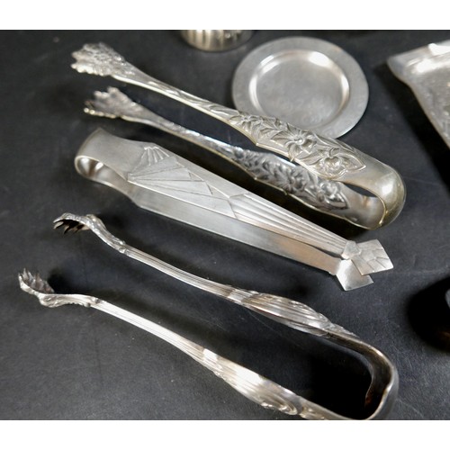 216 - A collection of fourteen pieces of white metal/plated items, including seven sugar nips. (1 bag)