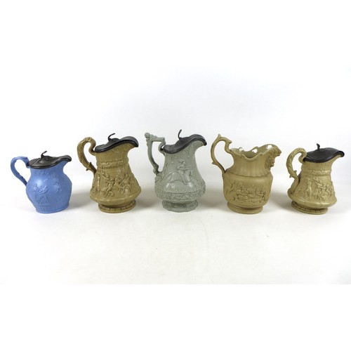 88 - A collection of five relief moulded stoneware jugs including monkeys playing cards, three other jugs... 