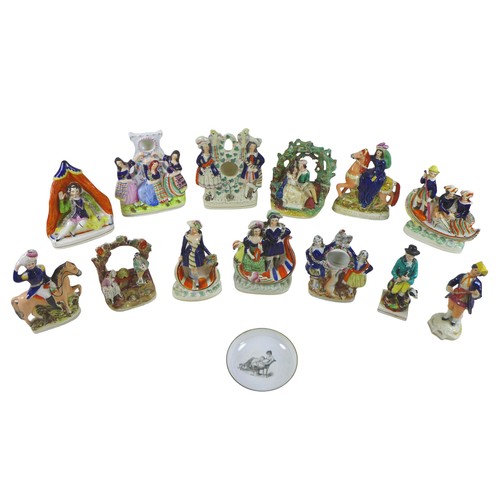 97 - A collection of thirteen Staffordshire figures and groups, including three watch holders, together w... 