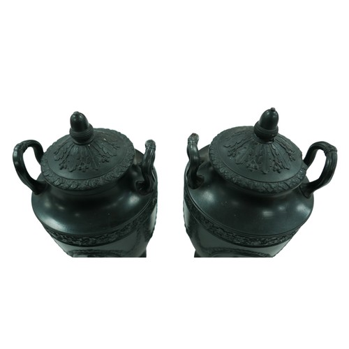 111 - A pair of mid 19th century Wedgwood black basalt twin-handled urns and covers, each decorated in Neo... 