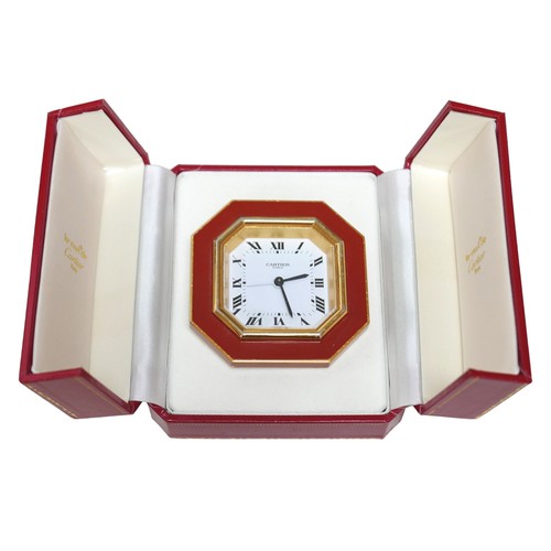 231 - A Cartier Must de travel clock, with octagonal case, with alarm, 7.5 by 7.5cm, together with its ori... 