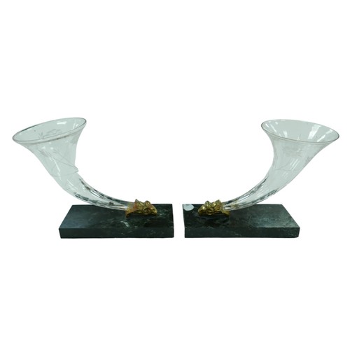 72 - A pair of 19th century engraved glass cornucopias, with ram's head terminals, raised upon marble bas... 