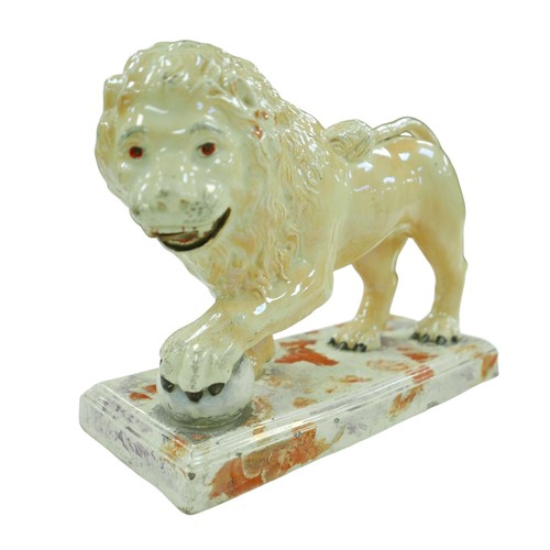 99 - A 18th century or later Staffordshire figurine modelled as a Medici lion, with for paw resting upon ... 