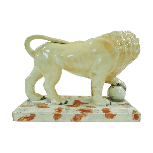 99 - A 18th century or later Staffordshire figurine modelled as a Medici lion, with for paw resting upon ... 