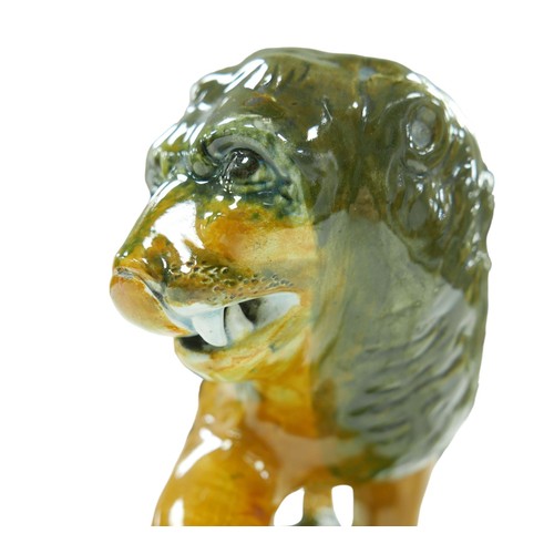 91 - A 18th century or later Staffordshire figurine modelled as a Medici lion, with for paw resting upon ... 