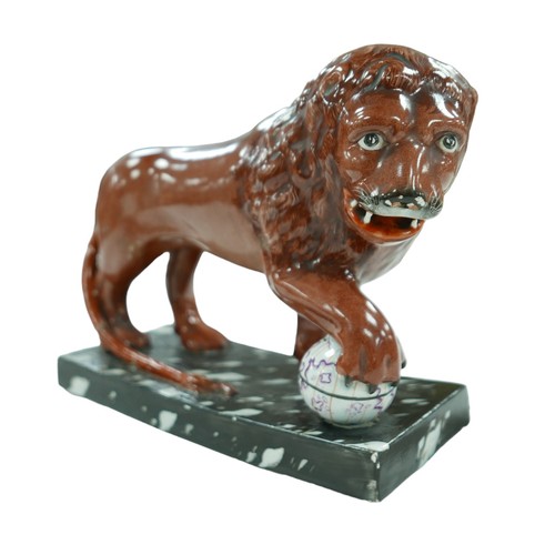 92 - A 18th century or later Staffordshire figurine modelled as a Medici lion, sangue de boeuf glazed lio... 