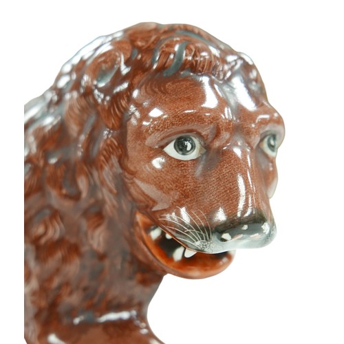 92 - A 18th century or later Staffordshire figurine modelled as a Medici lion, sangue de boeuf glazed lio... 