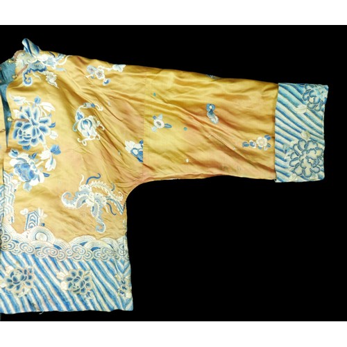 293 - An early 20th century Japanese jacket, decorated with blue chrysanthemums and butterflies on a gold ... 