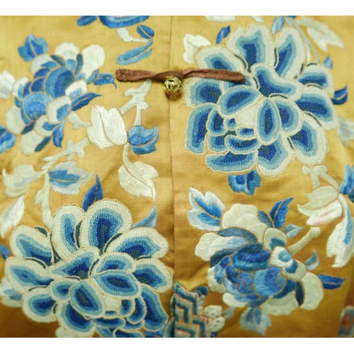 293 - An early 20th century Japanese jacket, decorated with blue chrysanthemums and butterflies on a gold ... 