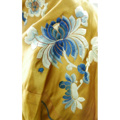 293 - An early 20th century Japanese jacket, decorated with blue chrysanthemums and butterflies on a gold ... 