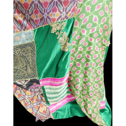 305 - A 1970s Thea Porter Couture kaftan, made of various green, pink, red and purple ground panels, adorn... 