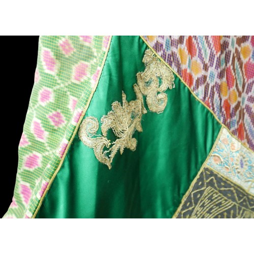 305 - A 1970s Thea Porter Couture kaftan, made of various green, pink, red and purple ground panels, adorn... 