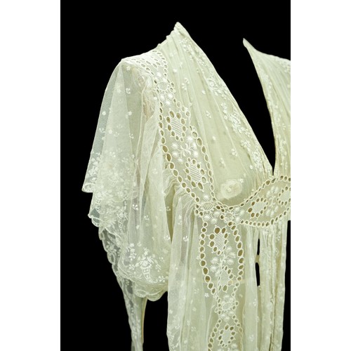 301 - An Edwardian lace gown, with ribbon ties and profuse embroidered detail.

Provenance: Privately owne... 