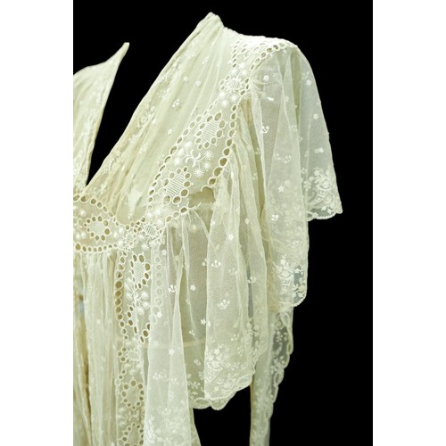 301 - An Edwardian lace gown, with ribbon ties and profuse embroidered detail.

Provenance: Privately owne... 