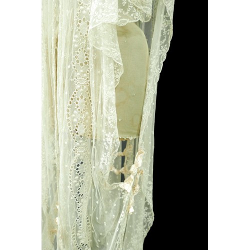 301 - An Edwardian lace gown, with ribbon ties and profuse embroidered detail.

Provenance: Privately owne... 