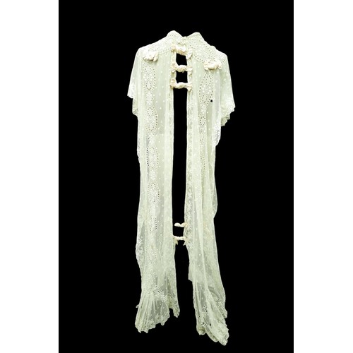 301 - An Edwardian lace gown, with ribbon ties and profuse embroidered detail.

Provenance: Privately owne... 