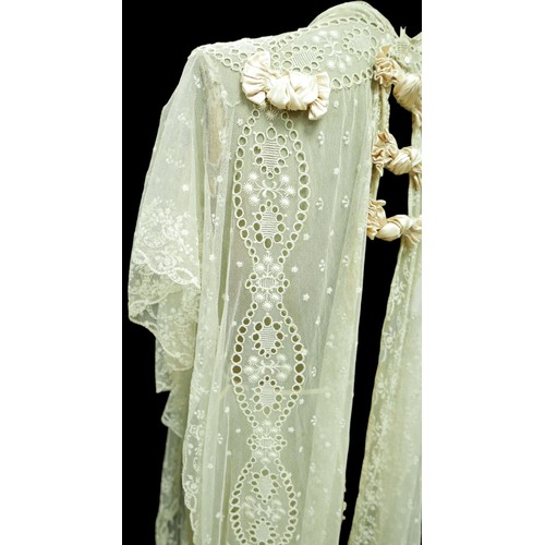 301 - An Edwardian lace gown, with ribbon ties and profuse embroidered detail.

Provenance: Privately owne... 