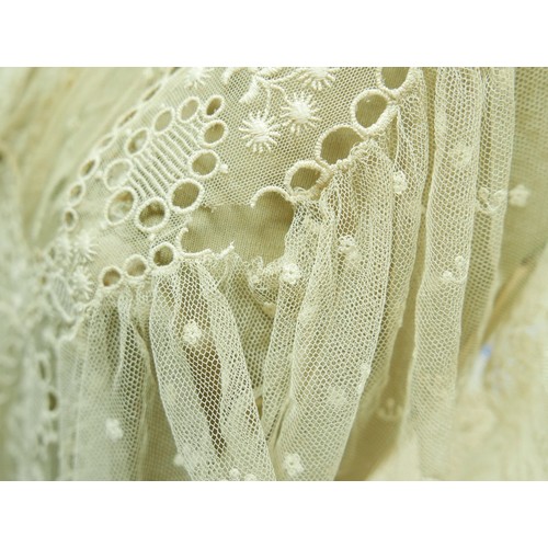 301 - An Edwardian lace gown, with ribbon ties and profuse embroidered detail.

Provenance: Privately owne... 