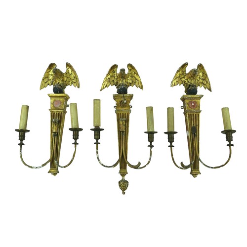 354 - Three 19th century giltwood and gesso wall sconces, each eagle surmounts, one with a ball and chain ... 