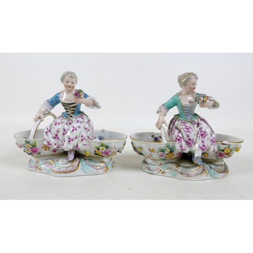 106 - A group of four 19th century Meissen salts, modelled as figures in 18th century attire sitting on tw... 